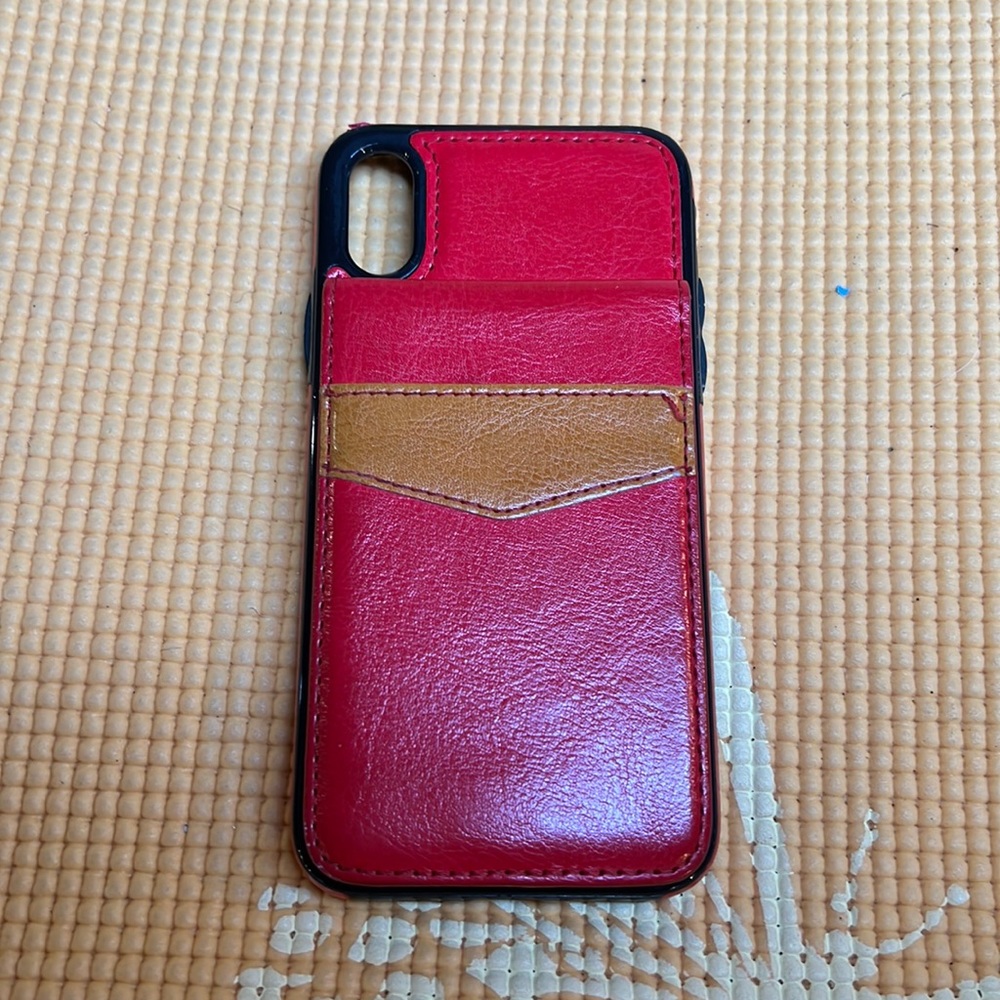 Red & beige IPhone XS case it has a flip up snap underneath to put CC/photo.